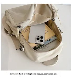 Top view of cream white nylon backpack showing spacious interior for iPad and essentials