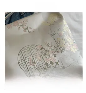 Detail of Chinese style jacquard fabric with pink flower patterns and window lattice design