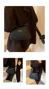 Detailed macro view of black quilted shoulder bag with golden metal buckle and knot strap