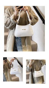 Close-up of white chevron quilted shoulder bag featuring gold hardware and knotted handle