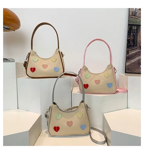Detailed straw texture underarm bags with colorful heart patches and stylish handles