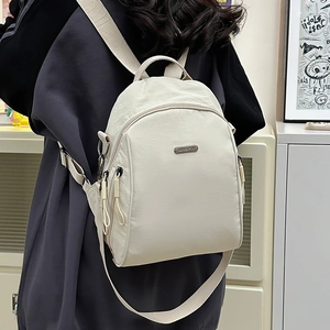 Off-white multi-functional backpack shown on model in a stylish indoor setting