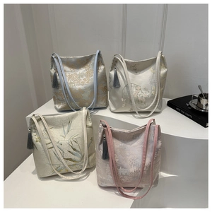 Detail of four jacquard embroidered tote bags with traditional Chinese landscape patterns