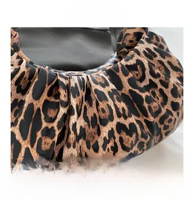 Close-up of pleated leopard print fabric and texture on the crescent hobo bag