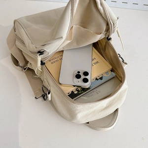 Minimalist beige nylon backpack with large capacity and organized interior compartments