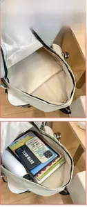 Internal display of the mint green backpack showing large capacity for laptop and books