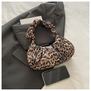 Detail of leopard print ruched handbag with scrunchie handle on a blazer