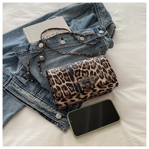 Detail of leopard print handbag with silver metal twist lock and leather chain strap