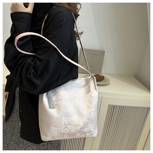 Detailed embroidery texture on a Chinese style jacquard shoulder bag with tassels
