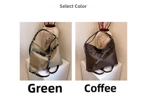 Detail view of large tote bag with leather straps and side buckle in green and brown