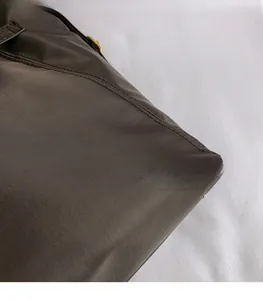 Close-up of durable brown textured fabric and precision stitching on the tote bag