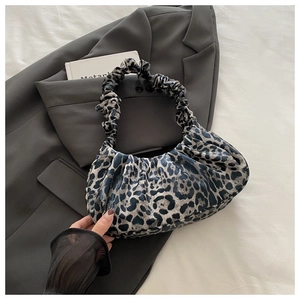 Detail of blue leopard print scrunchie handle bag with cloud-like pleats on fabric