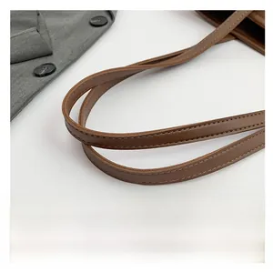 Close-up of the caramel brown leather shoulder strap with meticulous double stitching detail