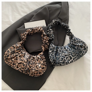 Detail showing ruched handles and leopard print texture on modern crescent cloud bags