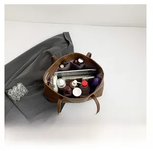 Spacious interior of brown tote bag with organized compartments for daily essentials