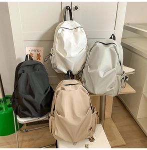 Macro display of minimalist campus backpacks in four colors showing waterproof nylon fabric