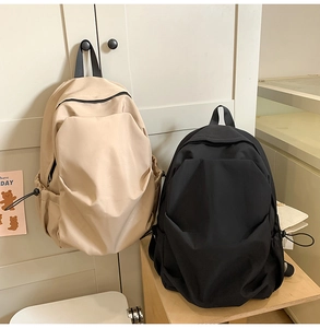 Minimalist nylon backpacks in beige and black featuring adjustable side drawstring pockets