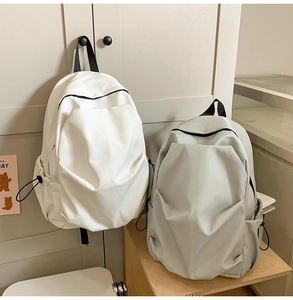 Detail of minimalist school backpacks with side drawstring pockets and front compartments