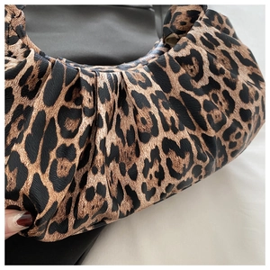 Detailed macro view of the ruched clouds bag featuring a classic leopard print texture