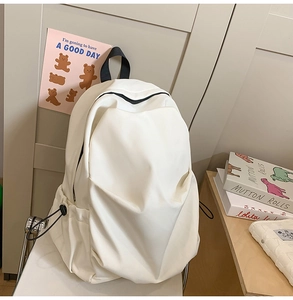 Minimalist white nylon backpack side detail with adjustable drawstring pocket design