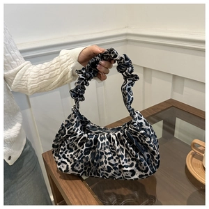 Detailed view of leopard print crescent bag featuring soft pleated velvet and scrunchie handle