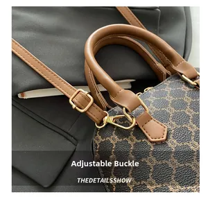 Detail of premium golden metal buckle and brown leather strap on retro patterned handbag