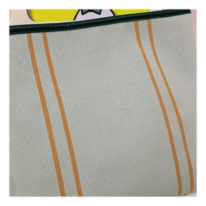 Close-up of mint green knitted handbag with orange stripes and dark green leather trim