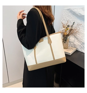 Close-up of minimalist white and beige tote bag with premium PU leather texture
