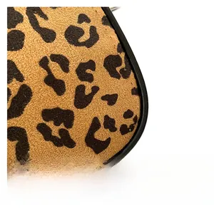 Close-up of leopard print fabric texture and high-quality black leather piping detail