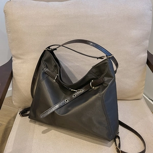 Retro brown large capacity tote bag in matte synthetic fiber on a beige sofa