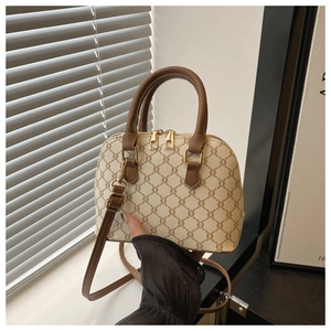 Detail of vintage beige shell bag featuring classic monogram print and brown leather trim