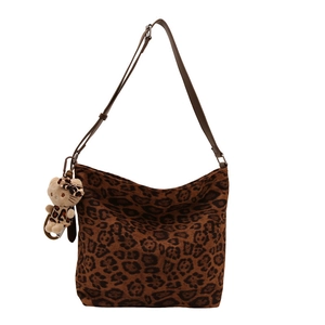Retro leopard print hobo bucket bag with a plush charm and brown leather strap