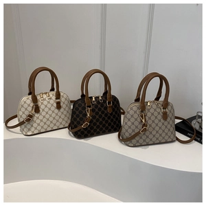 Three elegant vintage shell bags in white, black, and grey with classic monogram pattern