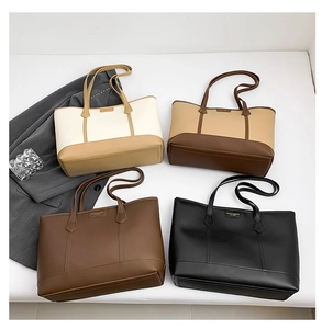 Flat lay of multiple color minimalist tote bags with fashion metal nameplate details