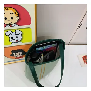 Spacious interior of canvas tote bag holding a tablet, phone and umbrella