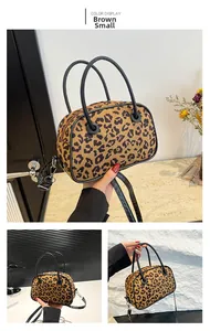 Detailed macro view of small leopard print handbag with plush texture and black handles