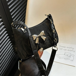Elegant black pleated underarm bag with silver bow accent and thick metal chain strap