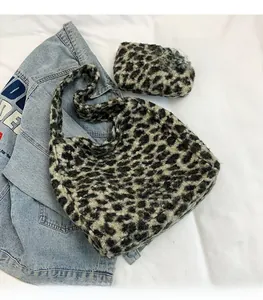 Detail of leopard print plush tote bag with matching zipper pouch on denim fabric