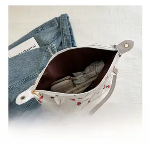 Interior view of strawberry print tote bag showing large capacity for umbrella and wallet