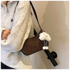 Side view of brown houndstooth shoulder bag with a cute white cloud plush pendant
