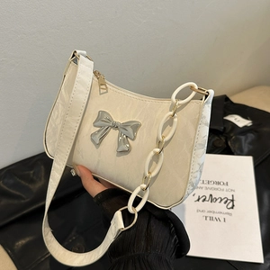 White crescent underarm bag with pleated texture and silver bow detail for women
