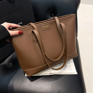 Minimalist brown leather tote bag with stylish shoulder straps for office and daily wear