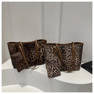 Detail of leopard print tote bag set featuring small zippered pouch and brown straps
