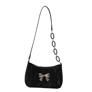 Black ruched underarm bag with silver bow detail and acrylic chain strap on white background