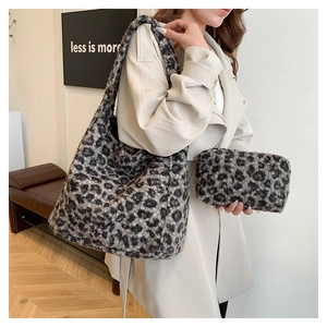 Close-up of leopard print plush tote bag set with soft faux fur texture and matching pouch
