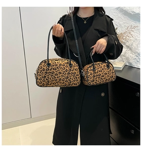 Detail view of stylish leopard print handbag and crossbody bag set worn by a model