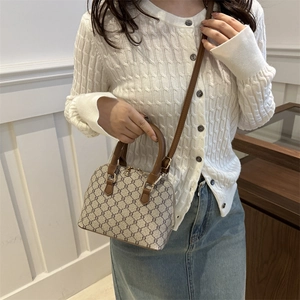 Vintage patterned beige shell handbag with brown leather straps and gold hardware detail