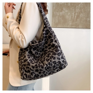 Chic leopard print plush tote bag styled with a white blazer for an autumn fashion look