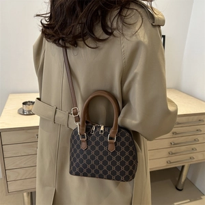 Vintage monogram shell handbag with leather trim and adjustable crossbody shoulder strap