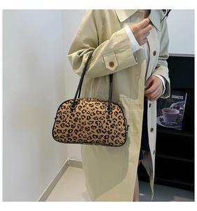 Leopard print handbag styled with a beige trench coat for a trendy casual commute look